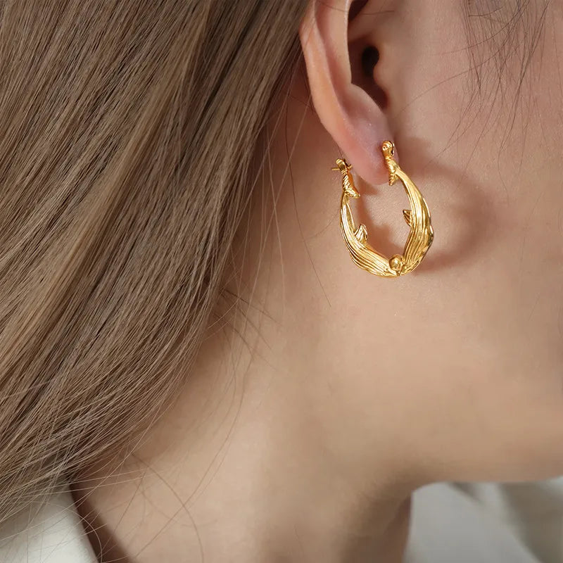 Kissing Dolphins Gold Plated Earrings On Model Ear Closeup Shot| Rebellious Gal Jewelry