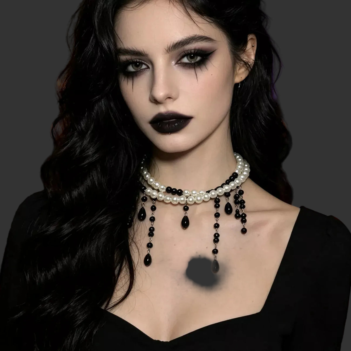 Pearl choker with black beaded drips worn with a black sweetheart neckline top