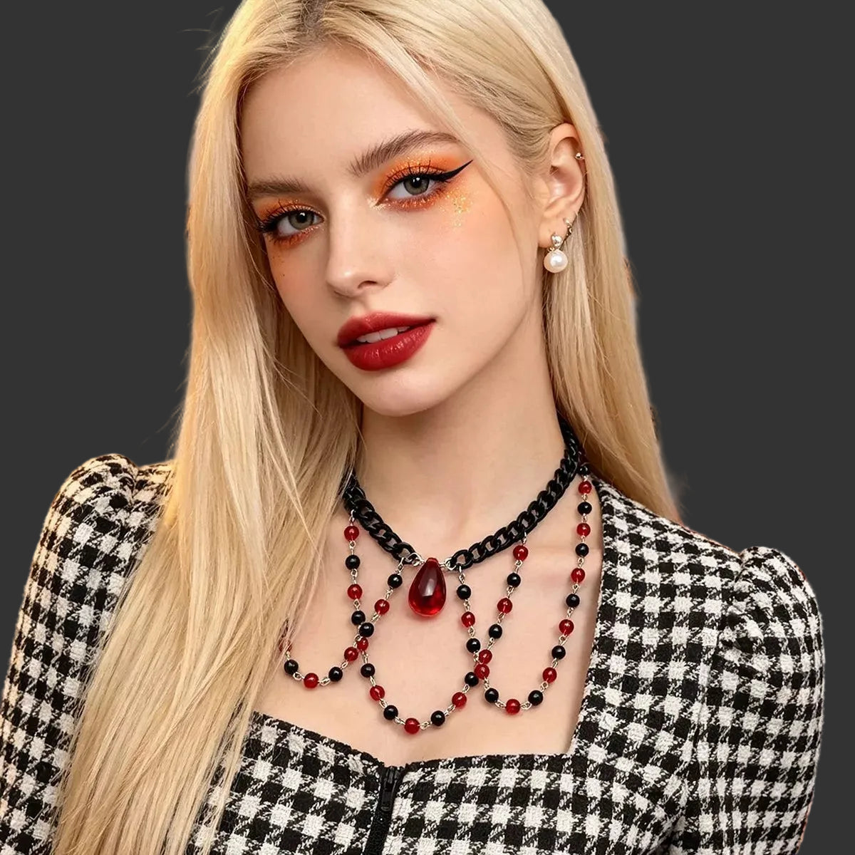 Red and black beaded choker worn with a black and white houndstooth jacket