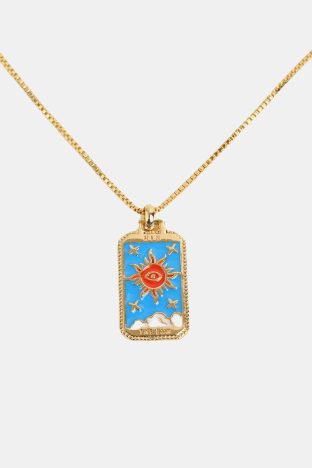 Gold necklace with a rectangular pendant featuring a sun design on a white background