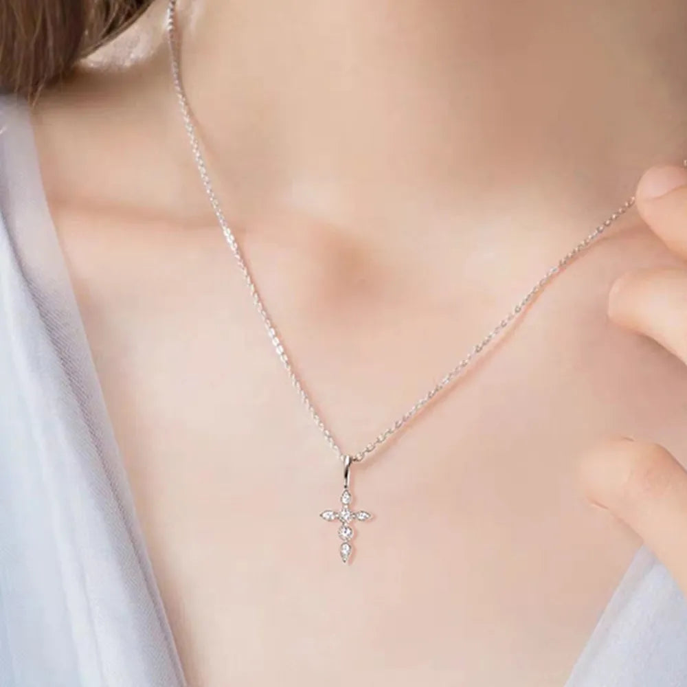 Overhead shot of one-size cross necklace displaying 15.7" chain plus extension