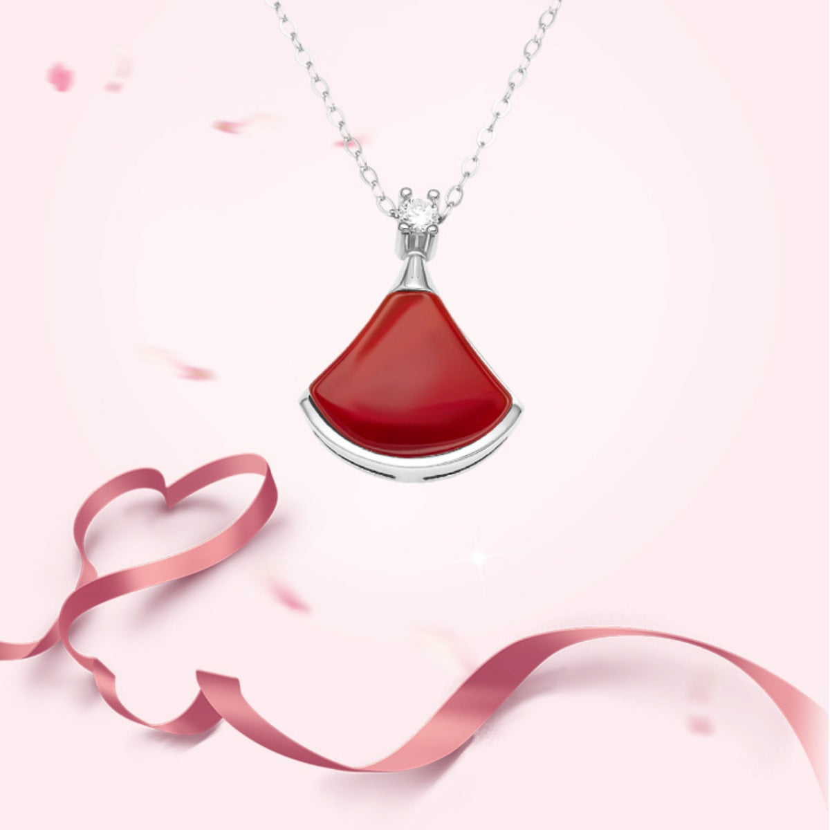 Close-up of vibrant red agate stone with zircon accents in sterling silver fan setting