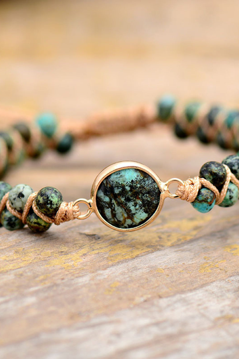 Close-up of natural pine wood beads and copper accents on adjustable bracelet
