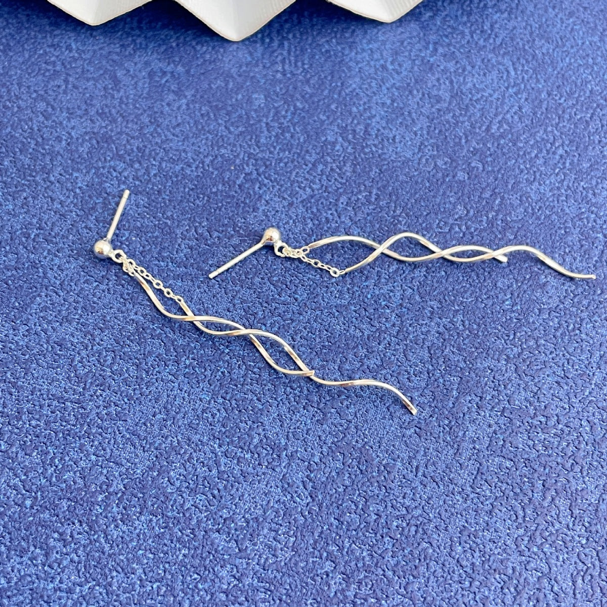 Rebellious Gal 925 sterling silver wave earrings front view on blue background