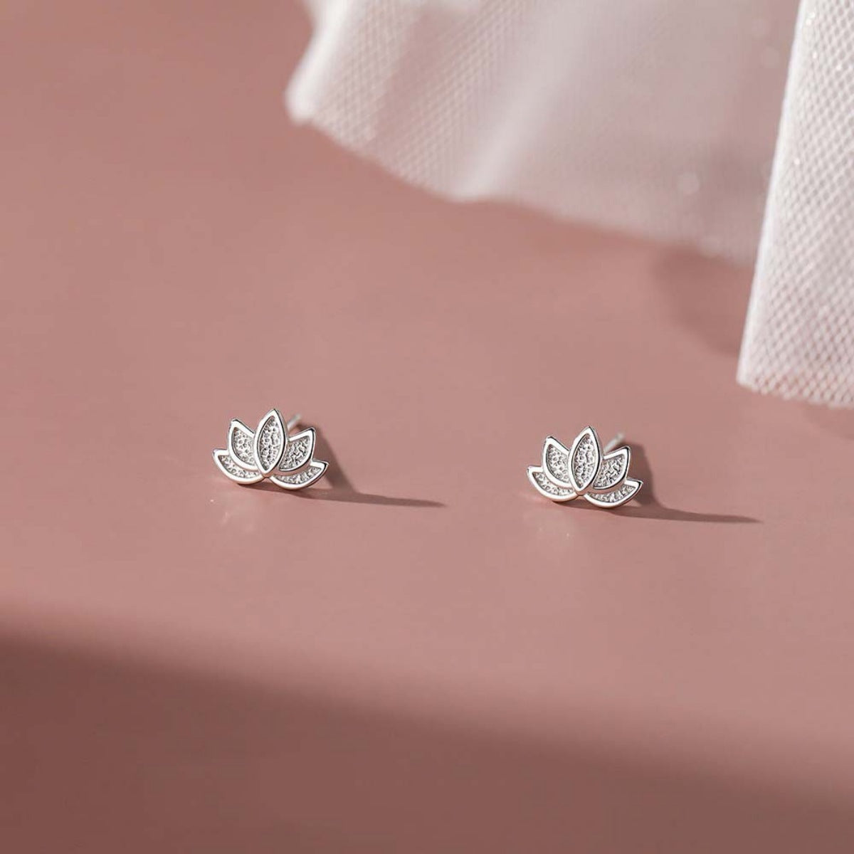 Lotus Flower Earrings worn on ear, showcasing delicate design