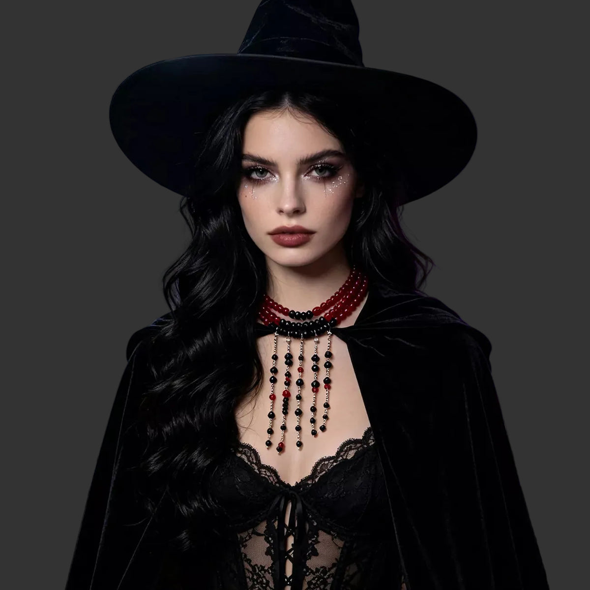 Red bead choker with black beaded fringe worn with a witch hat and velvet cloak