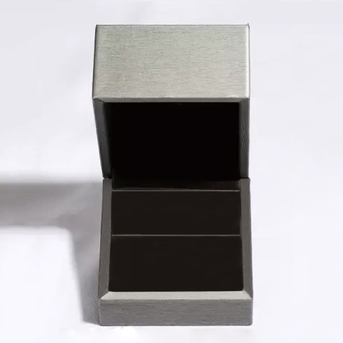 Product shot of 1ct moissanite ring arranged neatly with matching box and certificate
