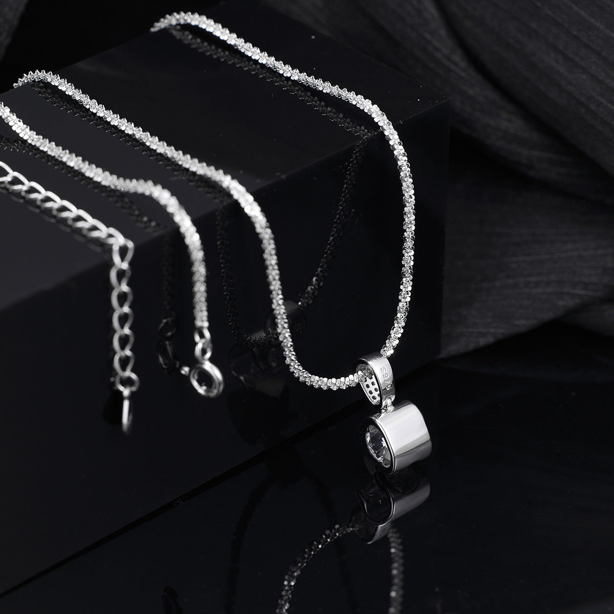 Detail shot of brilliant zircon and polished sterling silver setting