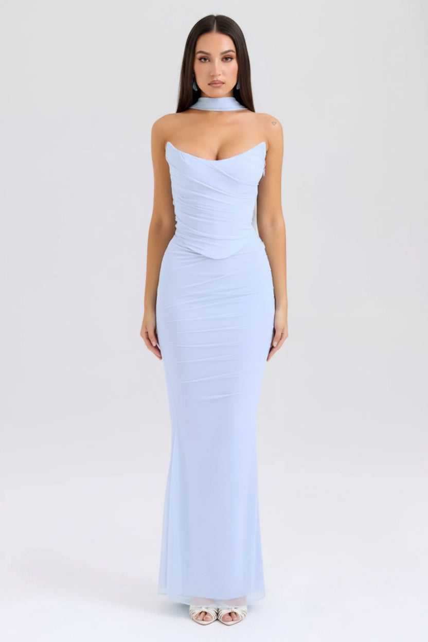 Woman wearing a light blue strapless gown on a white background