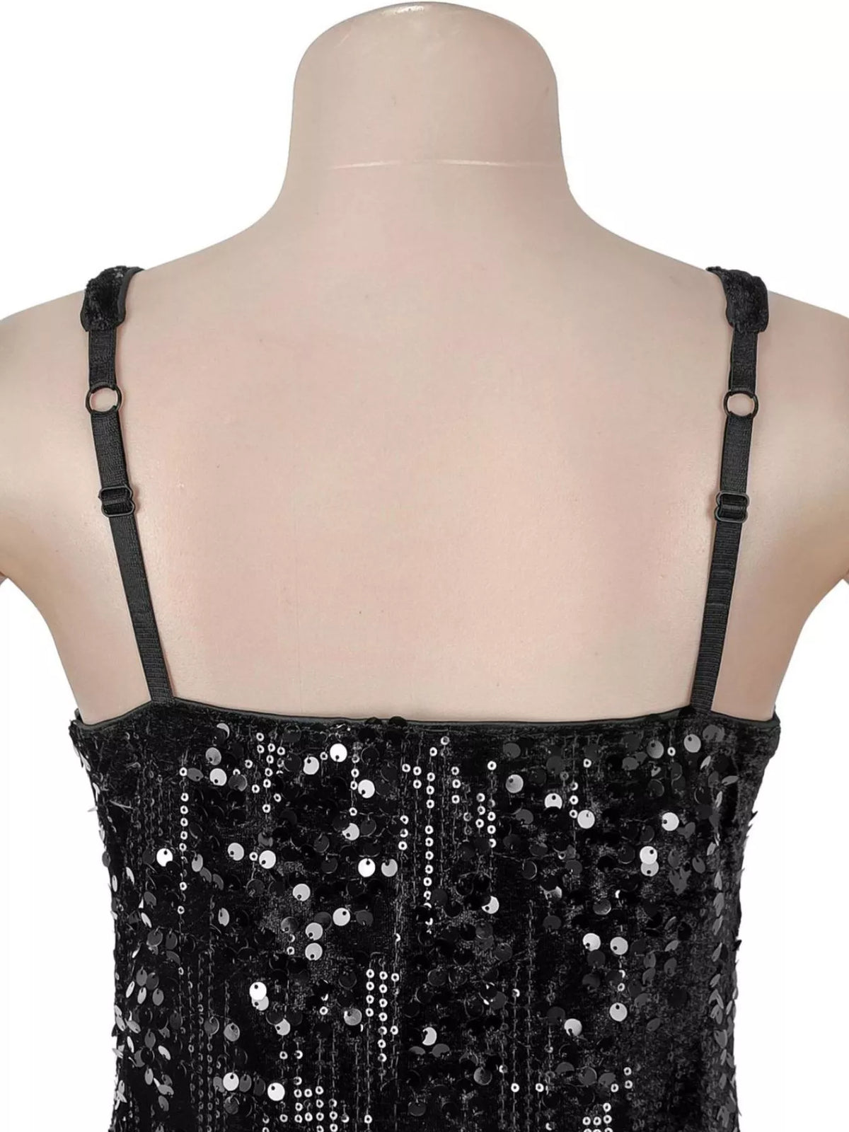Black sequin dress on a mannequin with a plain background