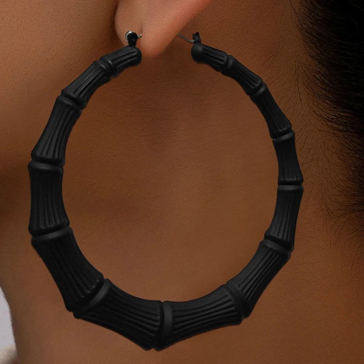 Rebellious Gal model wearing textured hoop earrings bold statement stack