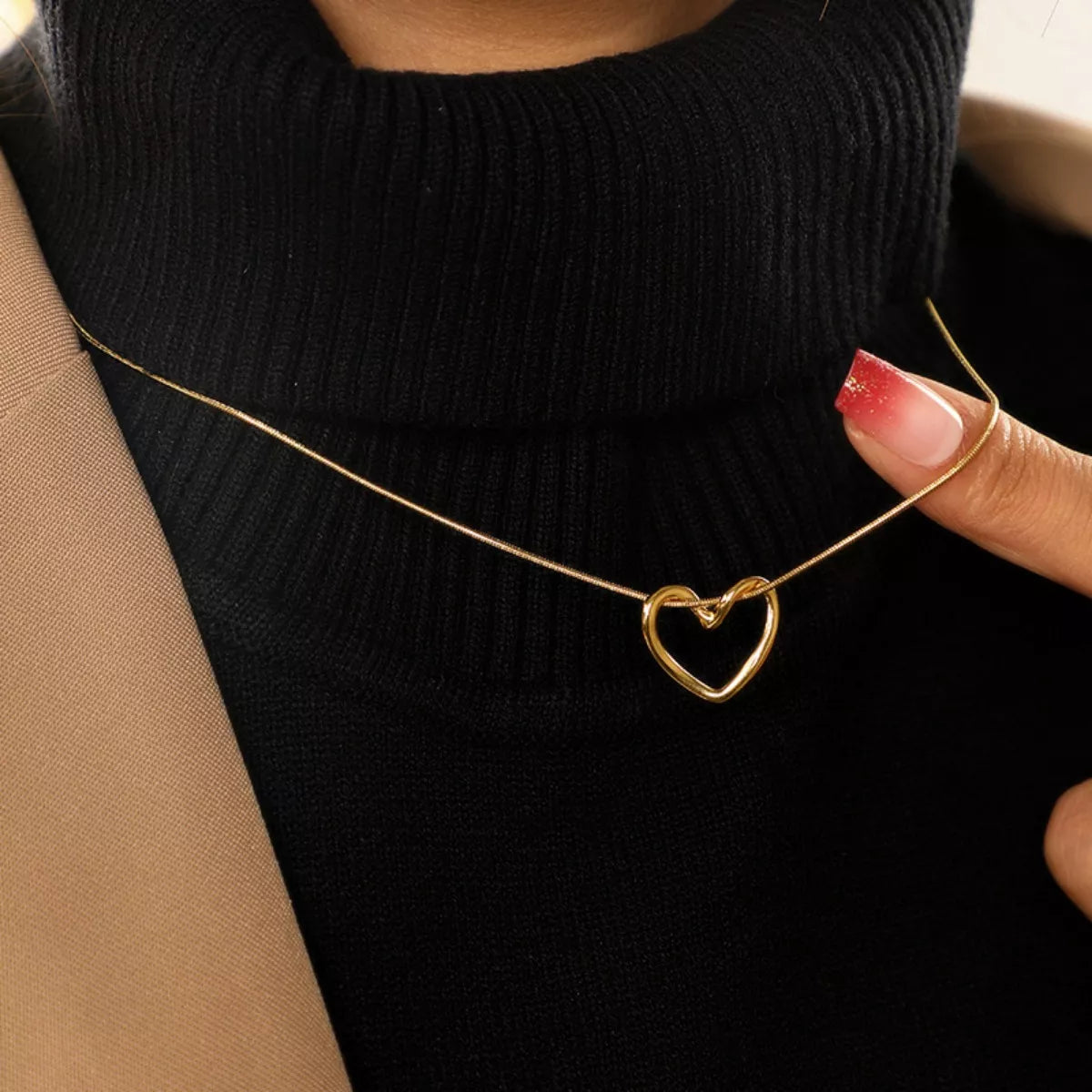 Close-up heart pendant detail on 18K gold plated stainless steel chain