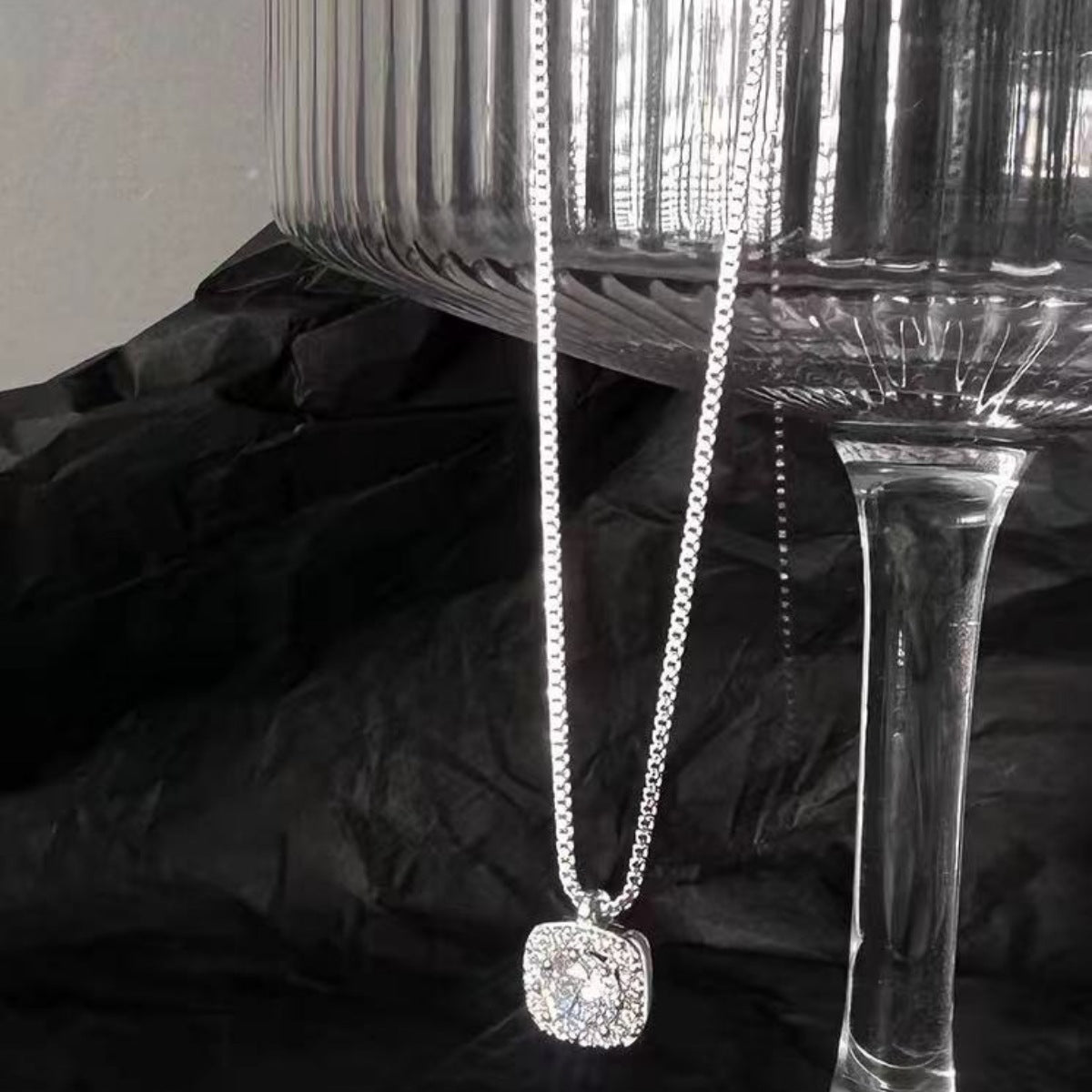 Detail shot of polished 925 sterling silver square frame and zircon accents