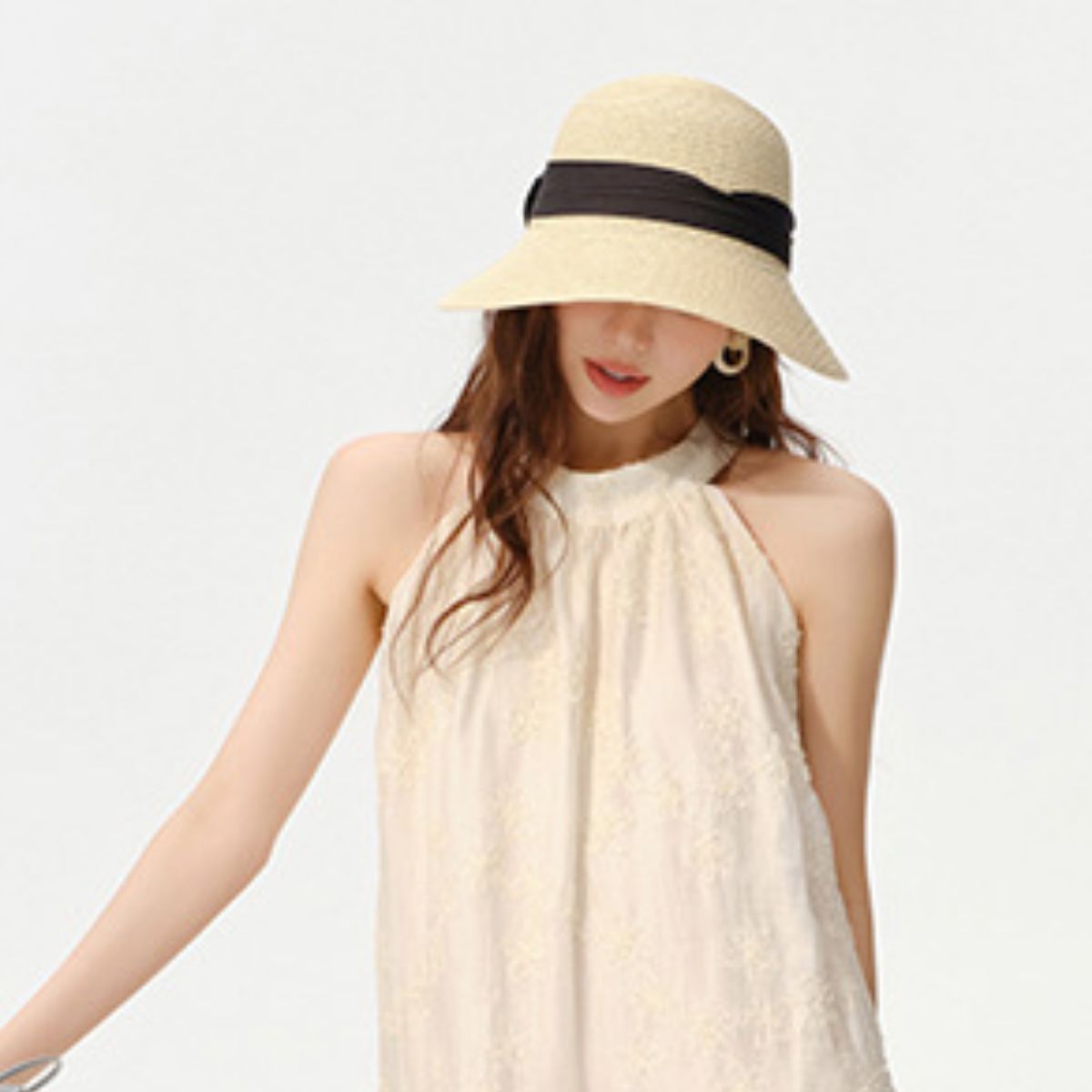 Straw style sun hat styled with summer outfit