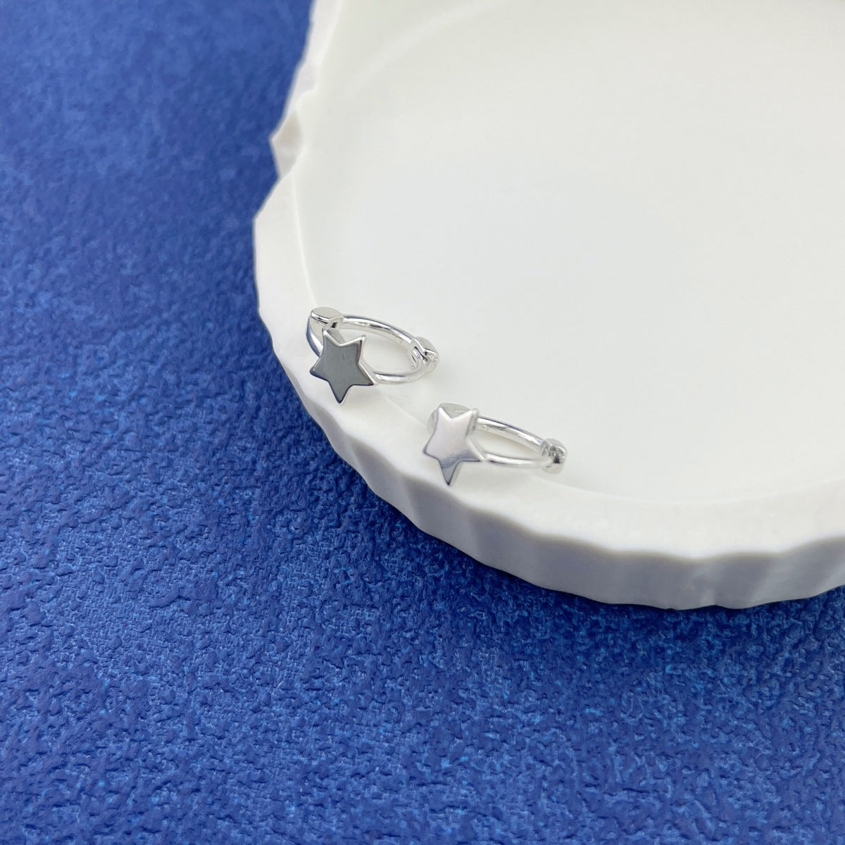 Close-up texture of smooth 925 sterling silver finish and star details