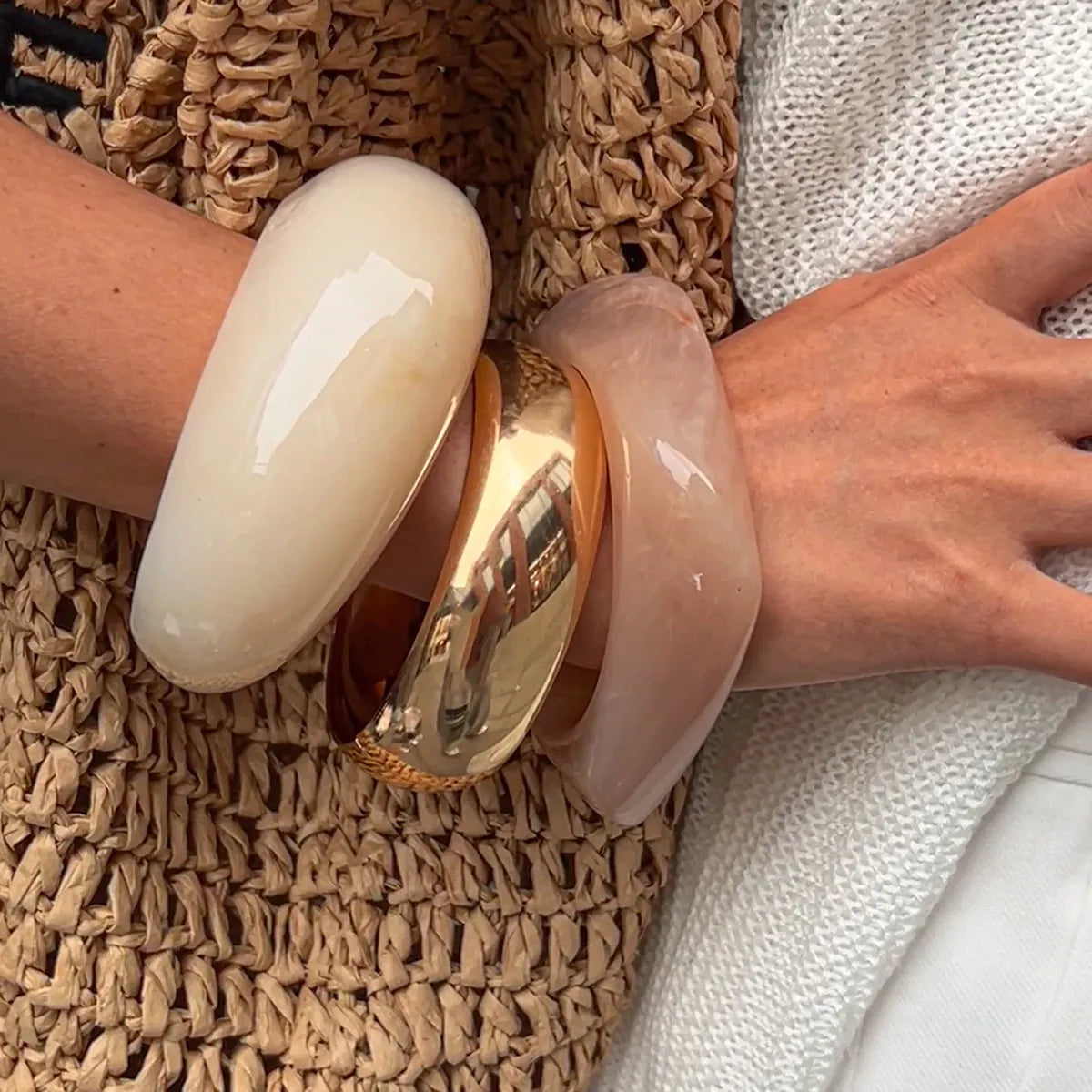 Close-up chunky resin bangles with 18K gold plating and textured detail