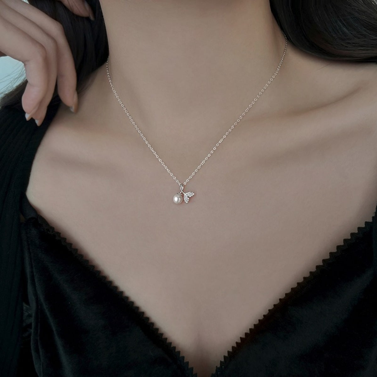 Detail shot of synthetic pearl texture and zircon stones set in sterling silver
