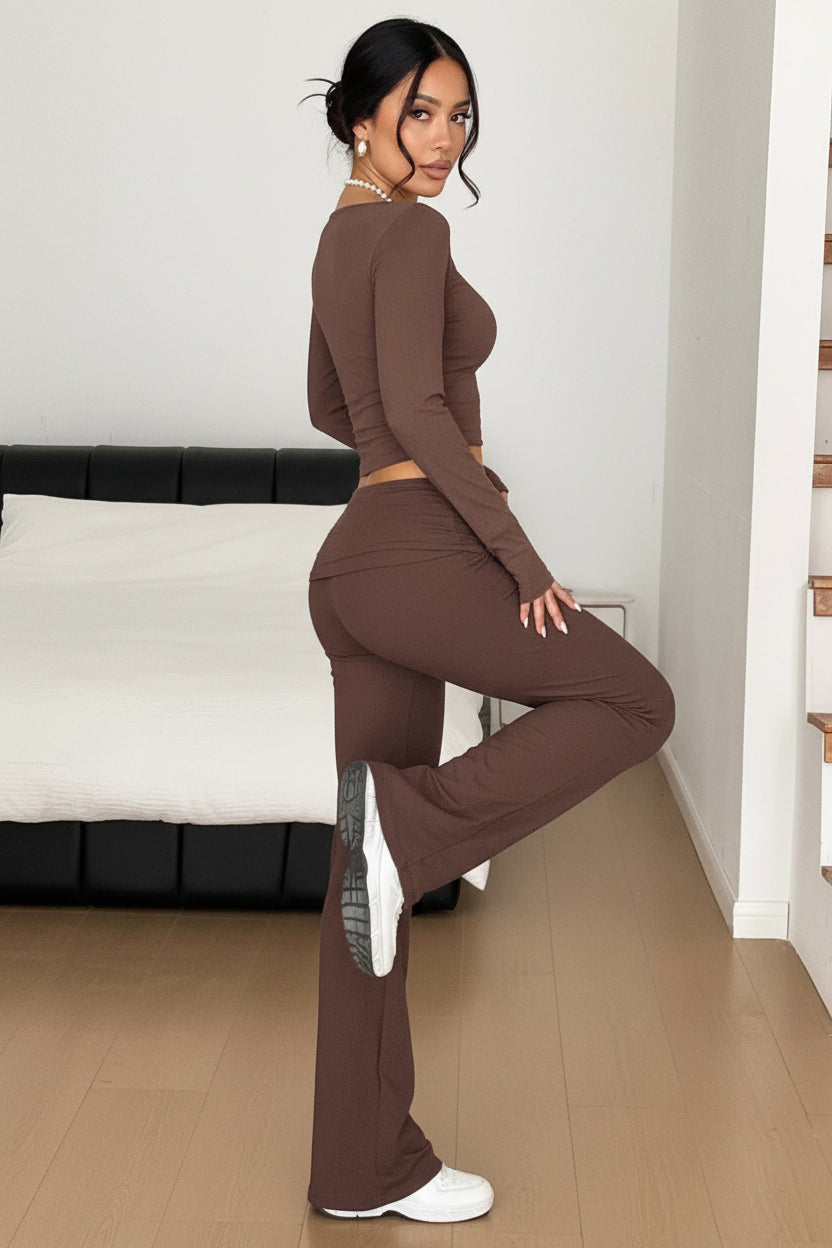 Person wearing a brown outfit in a minimal indoor setting