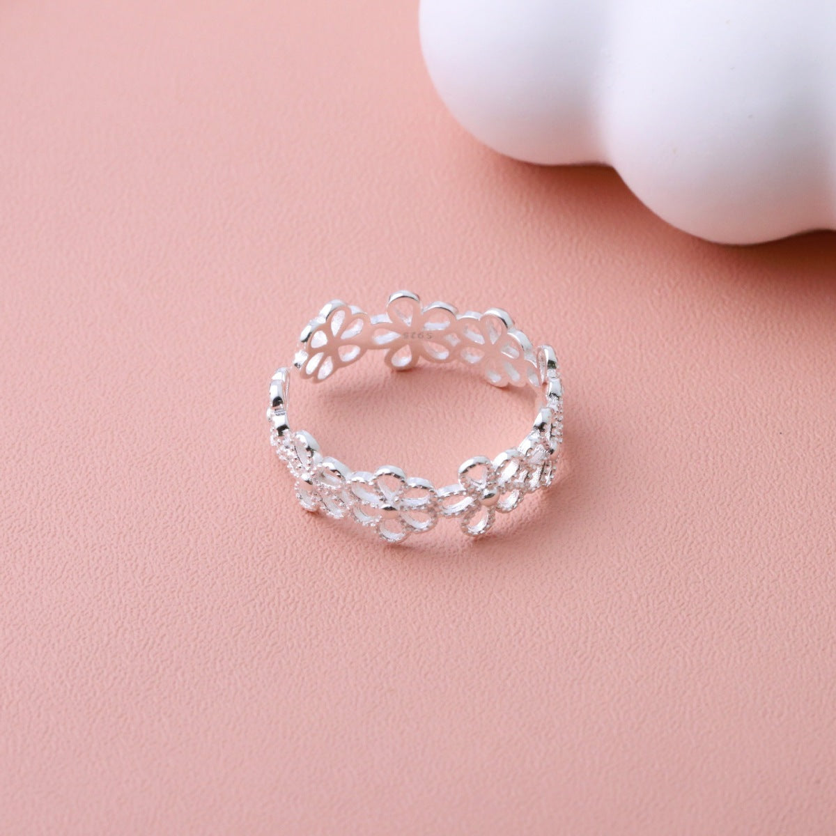 On-model finger shot showing how the floral ring sits elegantly on the hand