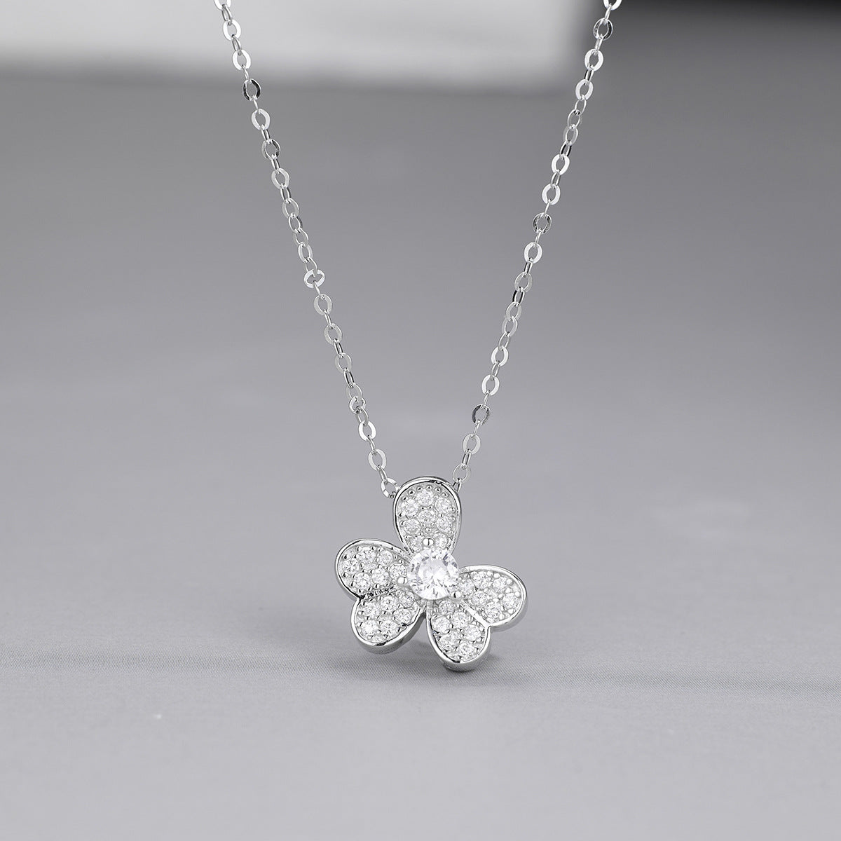 Zircon accented four leaf clover Silver pendant necklace sparkling in light