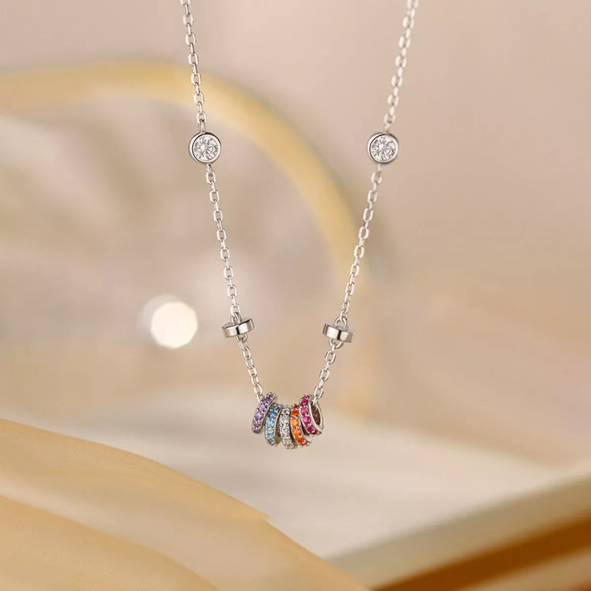 Rebellious Gal 18K rose gold-plated zircon pendant necklace front view on colourful background