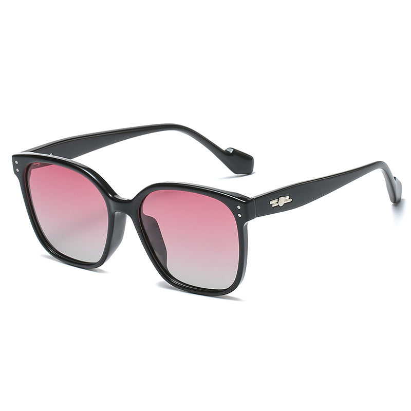 Close-up of gradient TAC lenses fading from dark to light in oversized polycarbonate frames