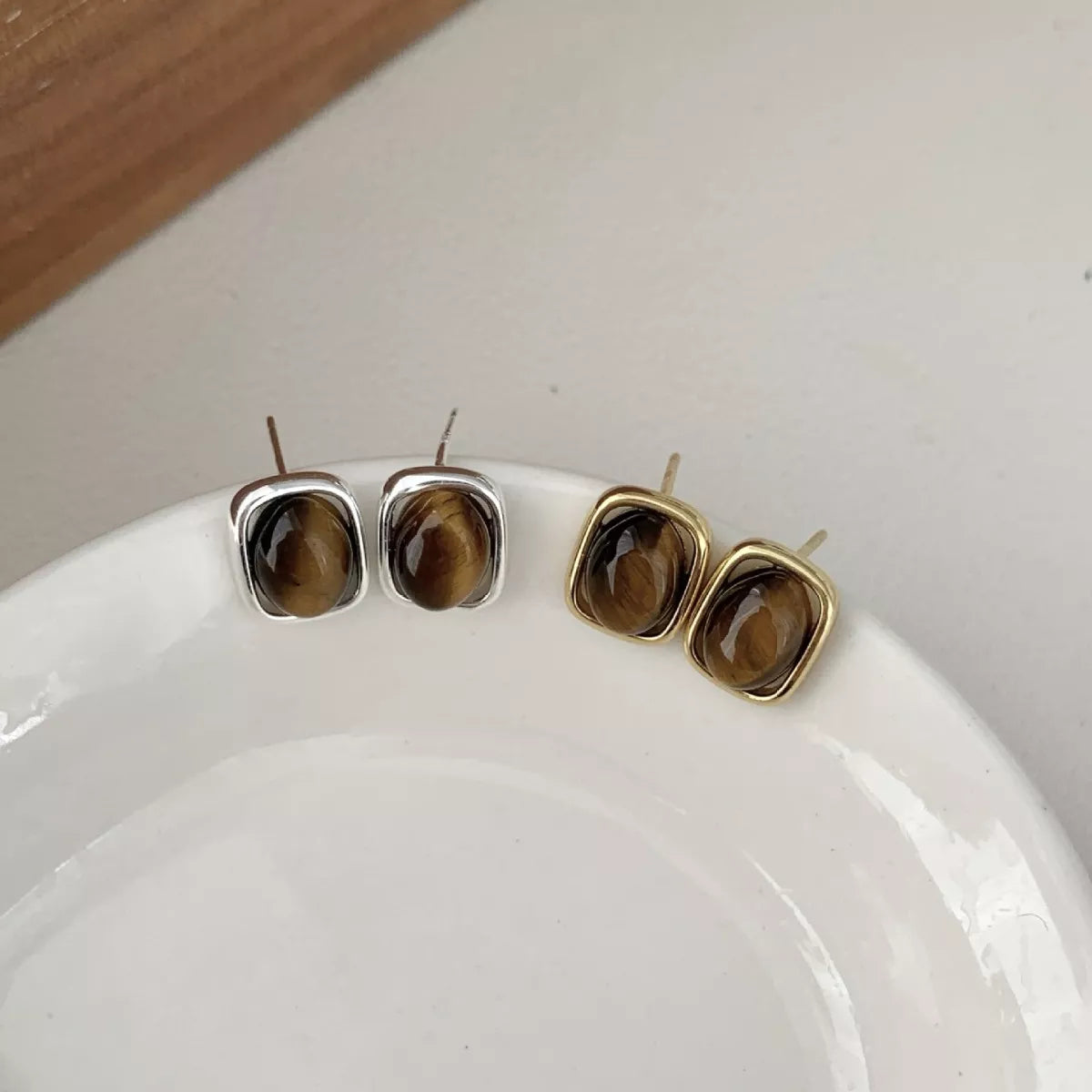 Rebellious Gal square tiger eye stud earrings 18K gold plated on white background
