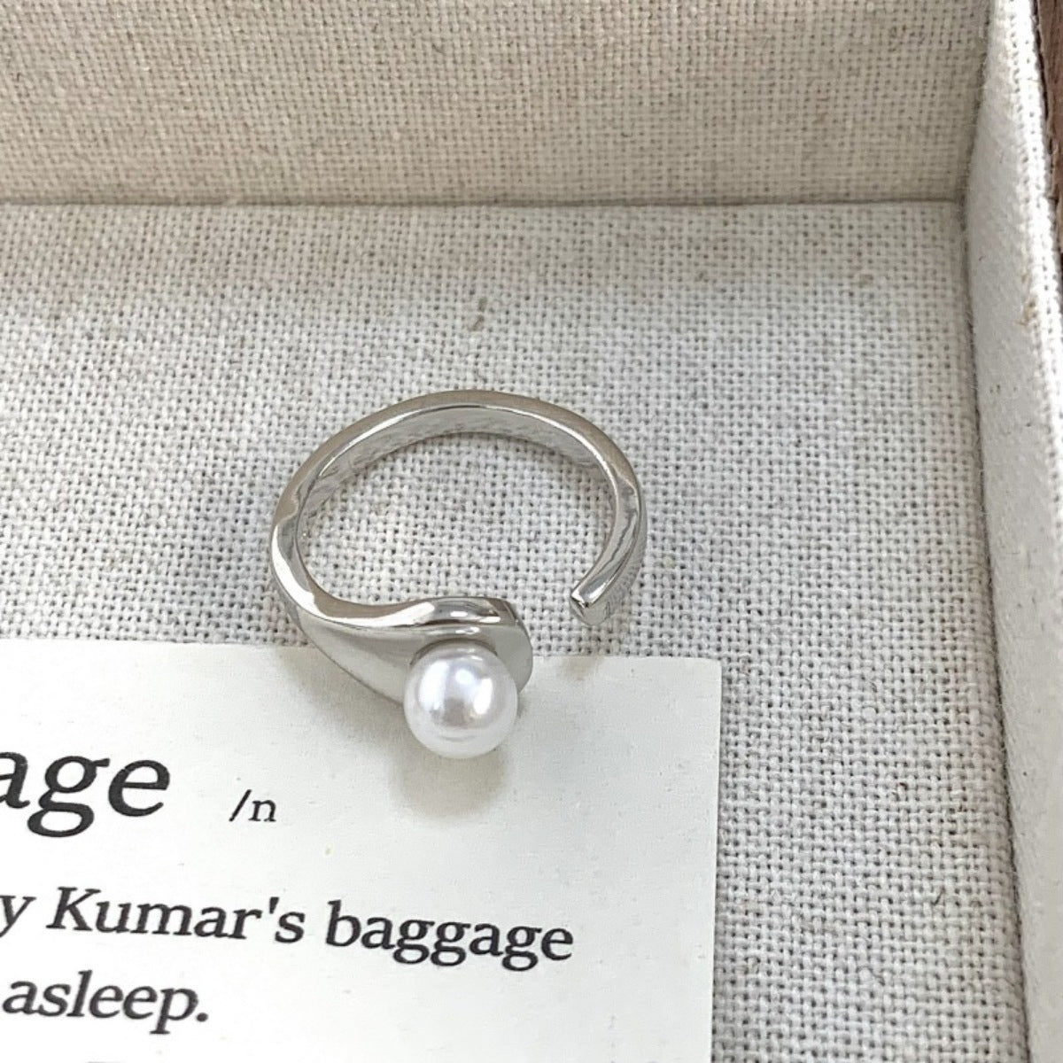 Product shot of pearl accent open cuff ring arranged neatly with matching box