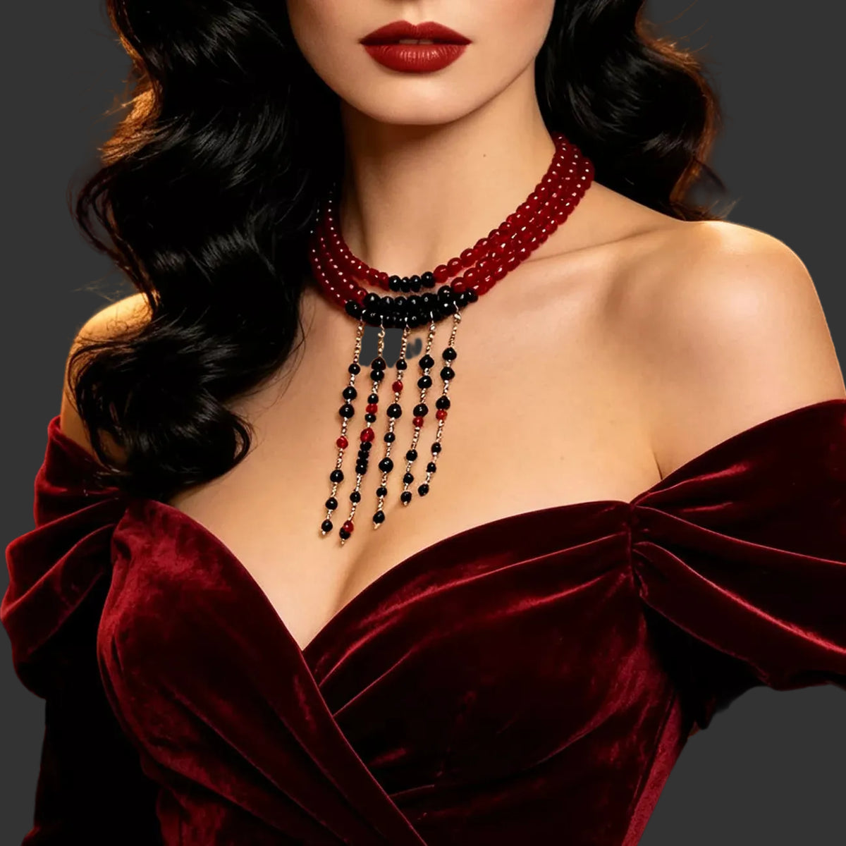 Red bead choker with black beaded fringe worn with a burgundy velvet gown