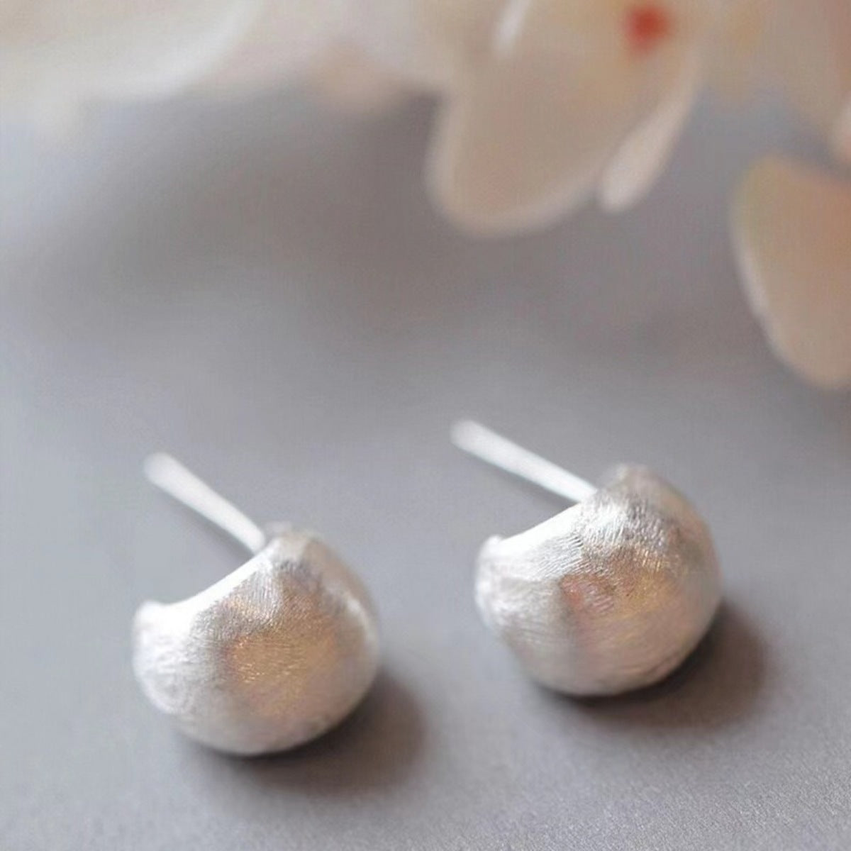 Lifestyle image of model wearing silver C-Hoop Earrings