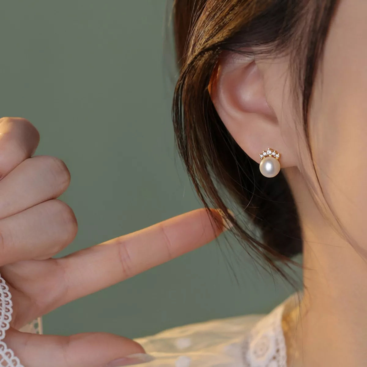 Rebellious Gal freshwater pearl stud earrings 0.4" worn close-up on ear natural light