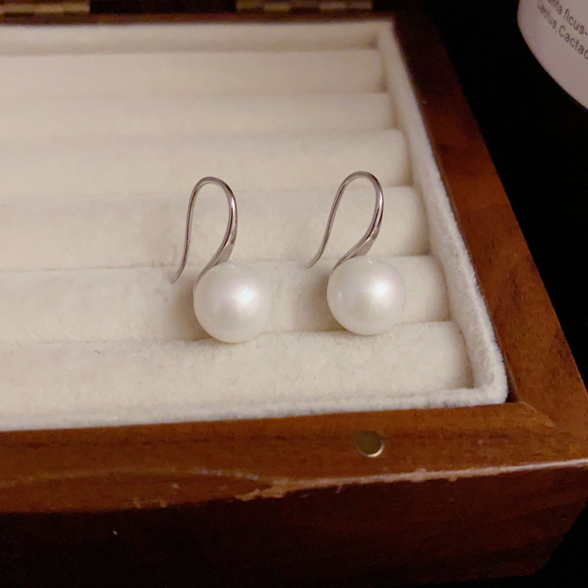 Pearl earrings in a wooden jewelry box