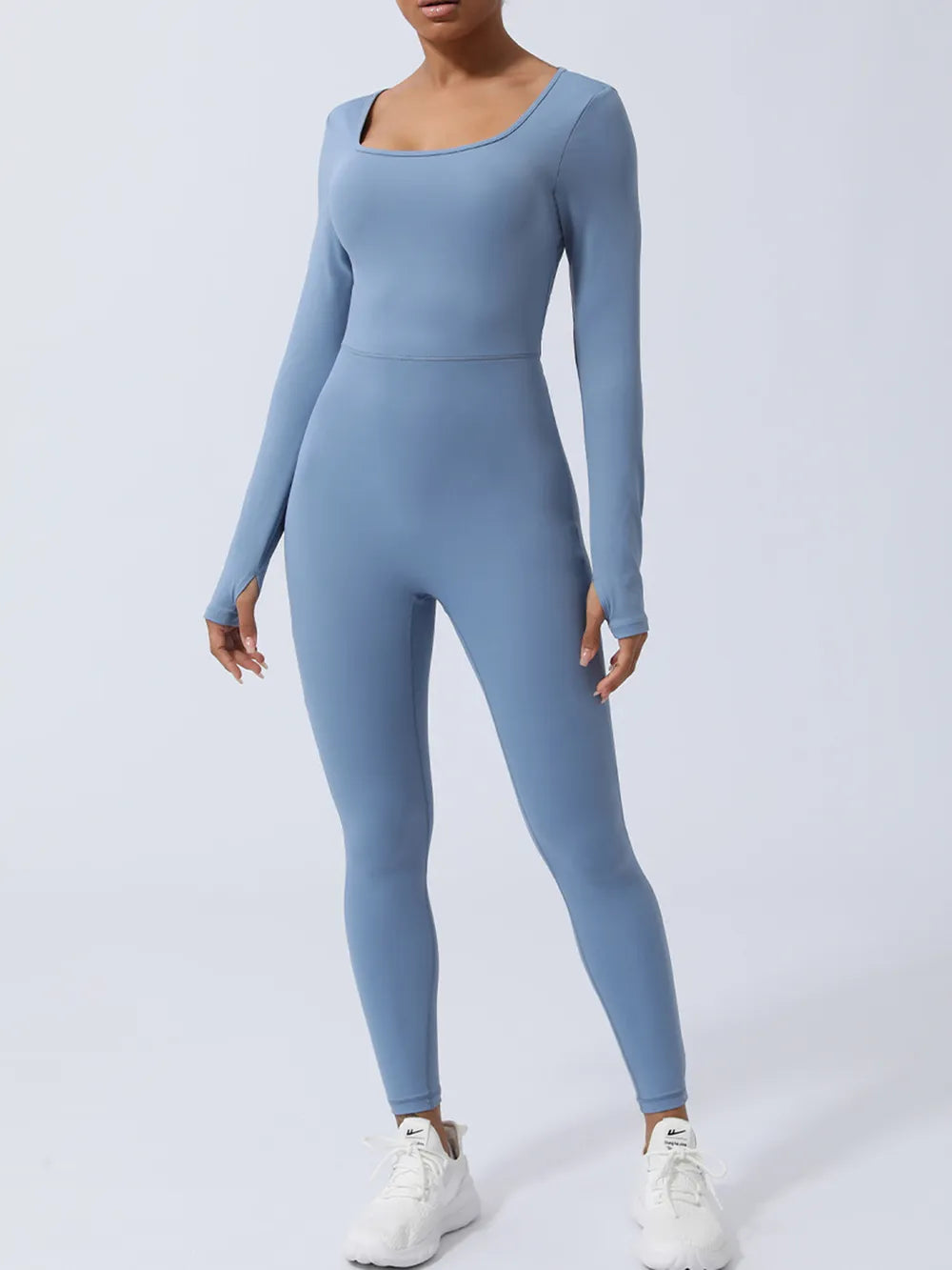Dusty blue jumpsuit facing forward, long sleeves to the hands, seam across the natural waist