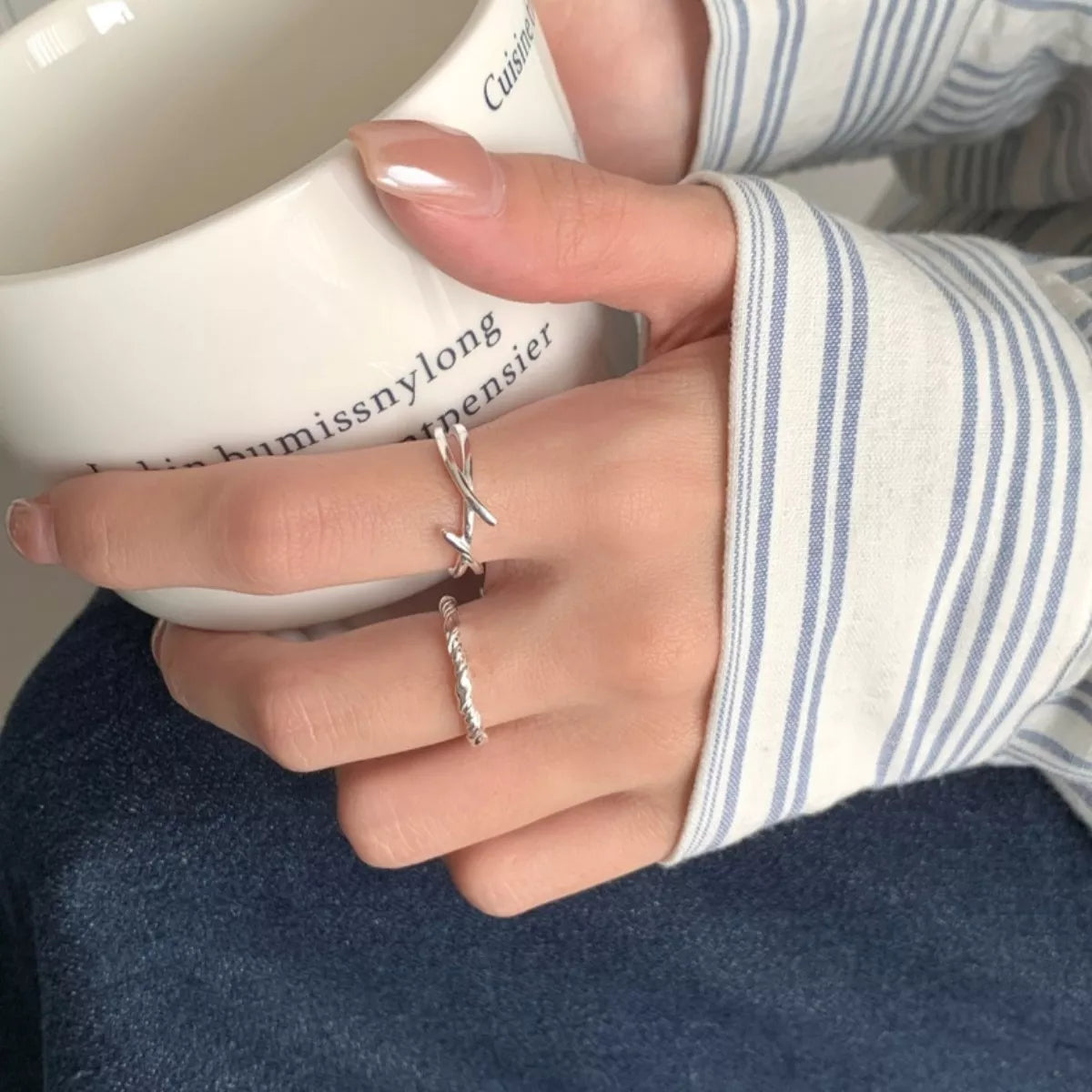 Model wearing Rebellious Gal open silver ring with rebellious layered jewelry