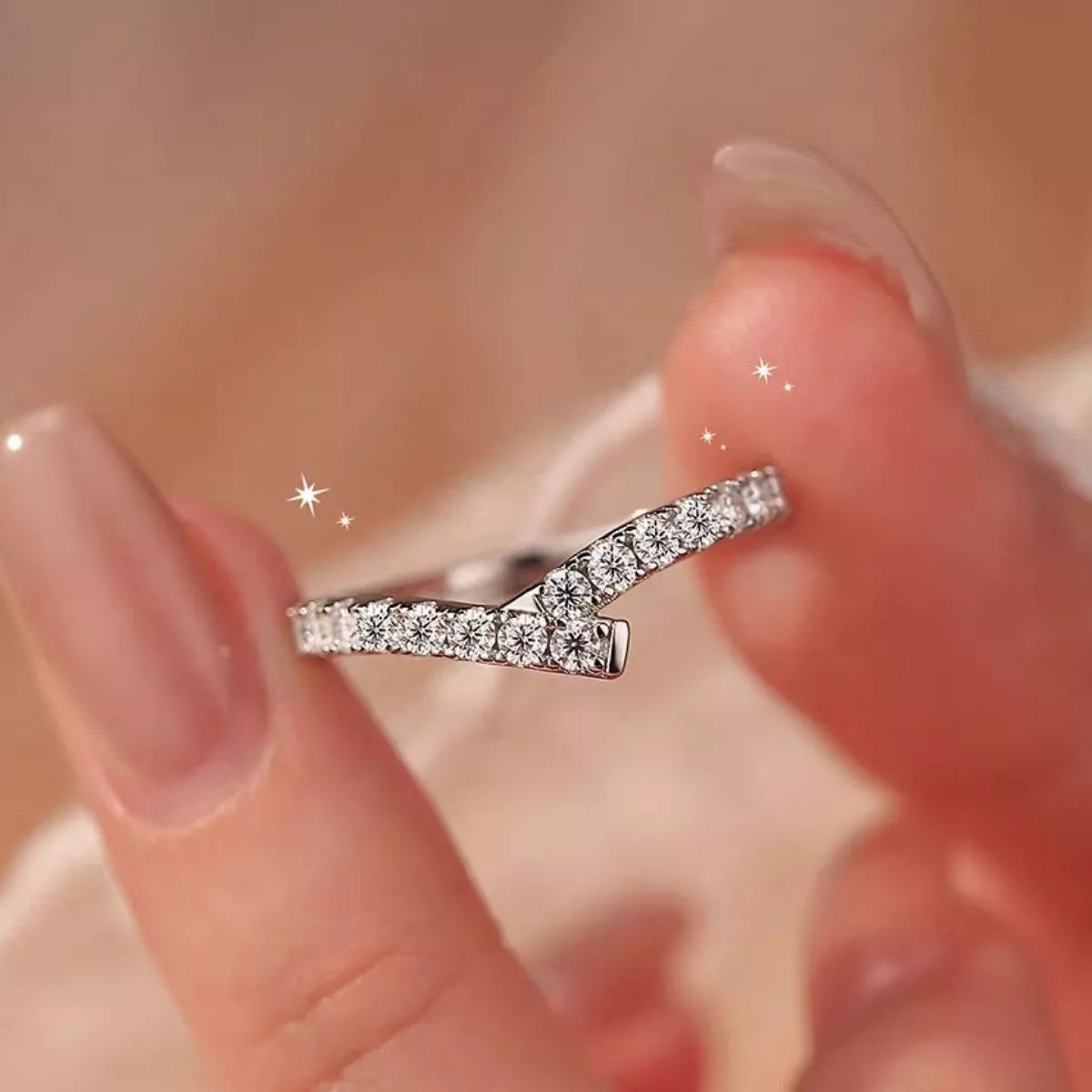 Silver ring with diamonds on a blurred background