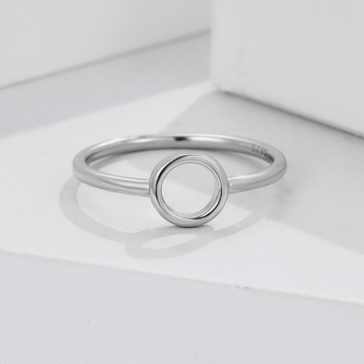Flat lay of sterling silver circle ring with matching luxury gift box