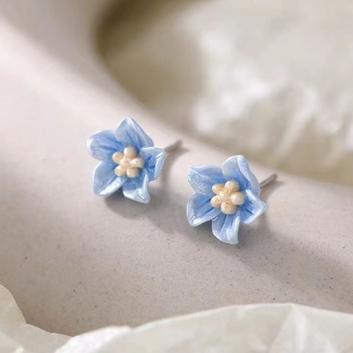 Close-up of small floral earrings detail