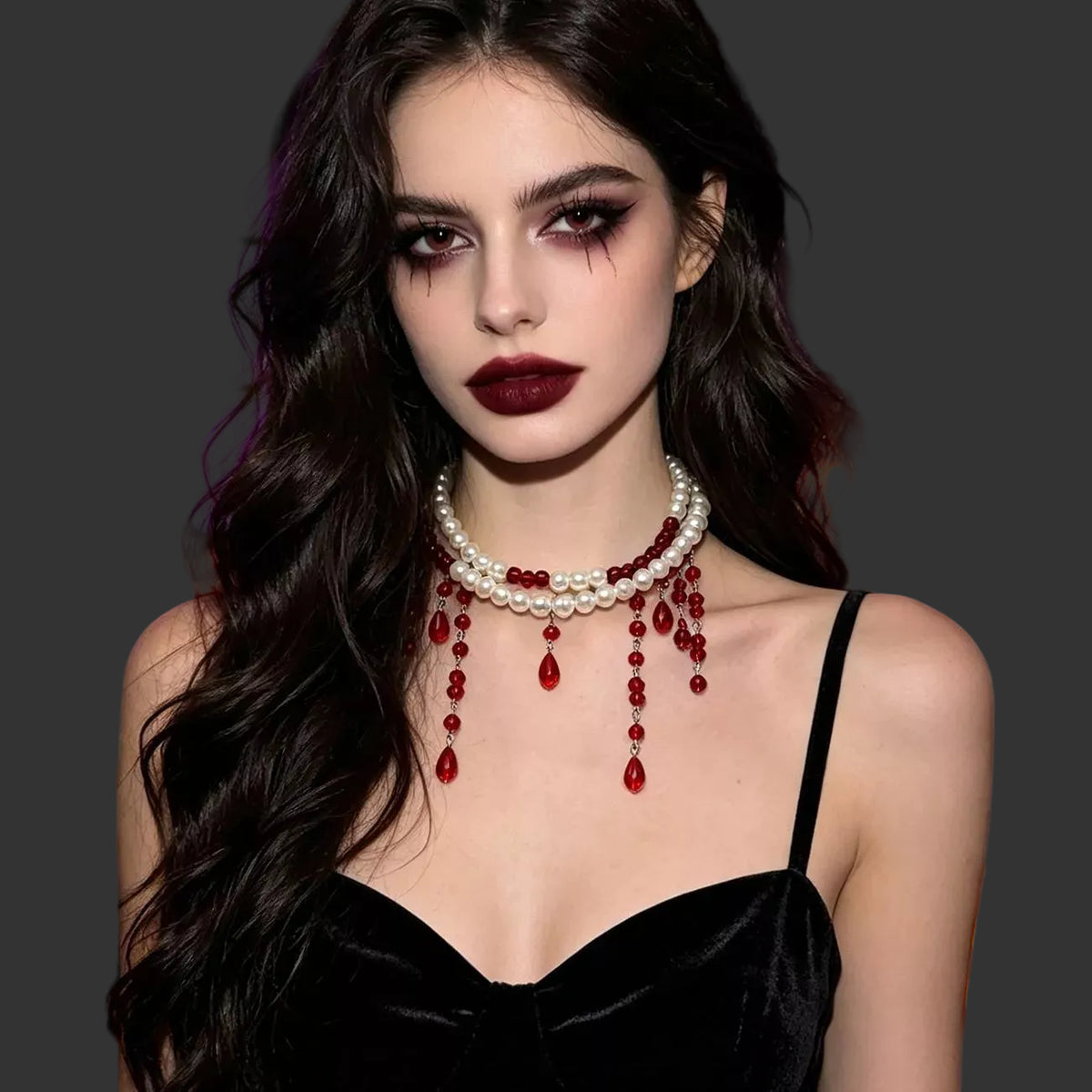 Pearl choker with red beaded drips worn with a black velvet camisole