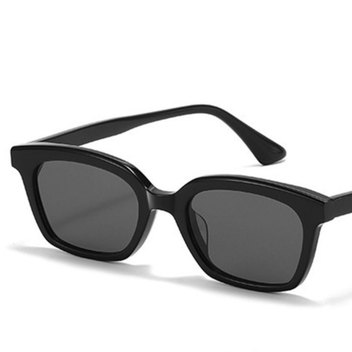 Side profile of sleek acetate frame sunglasses showing curved temple design