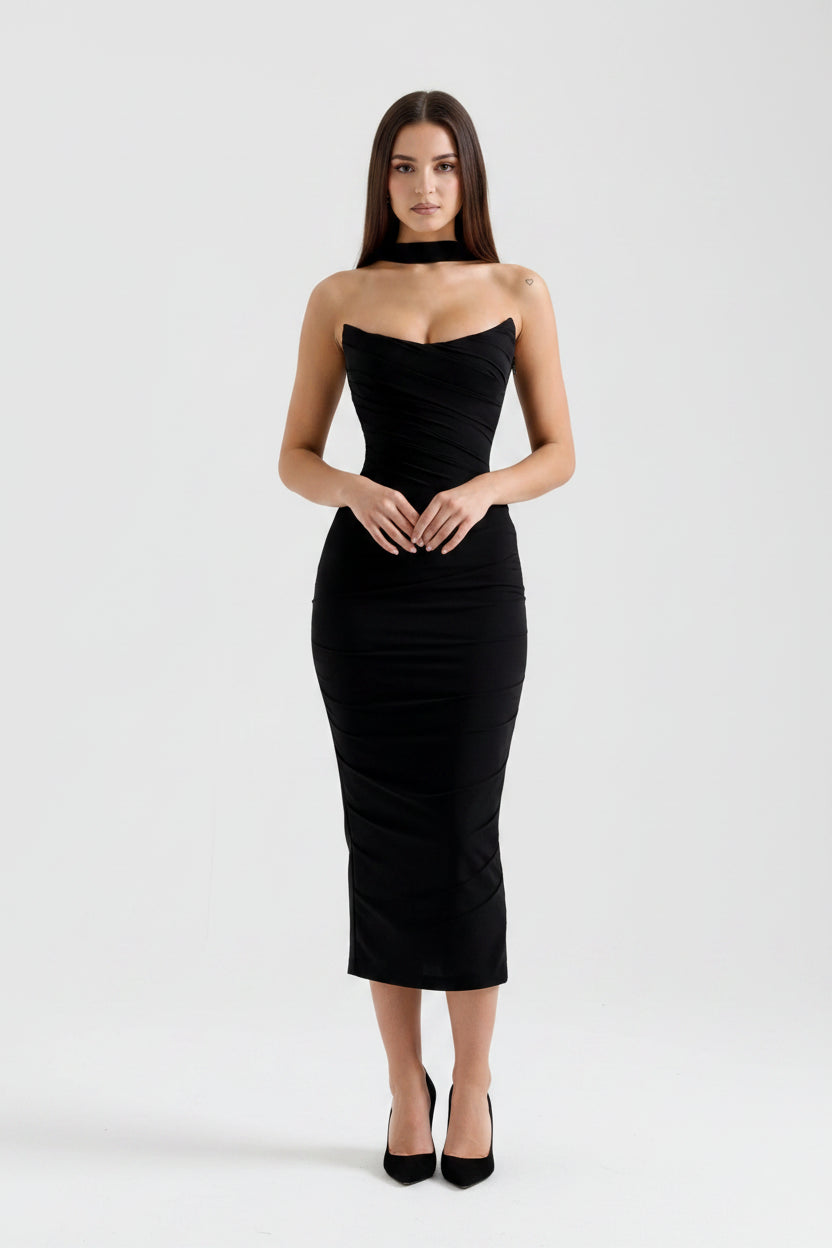 Black strapless dress worn by a model on a white background