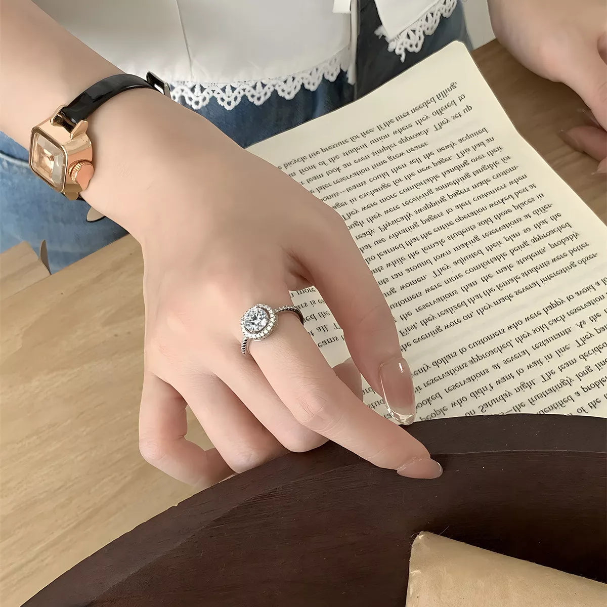 Model wearing Rebellious Gal 1 carat moissanite ring with rebellious layered jewelry