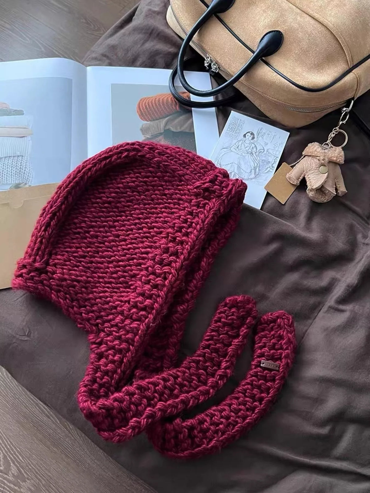 Knitted hooded scarf hat styled with edgy outfit and chunky boots rebellious vibe