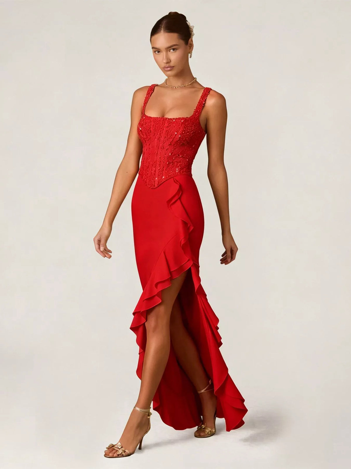 Woman wearing a red evening gown with a white background
