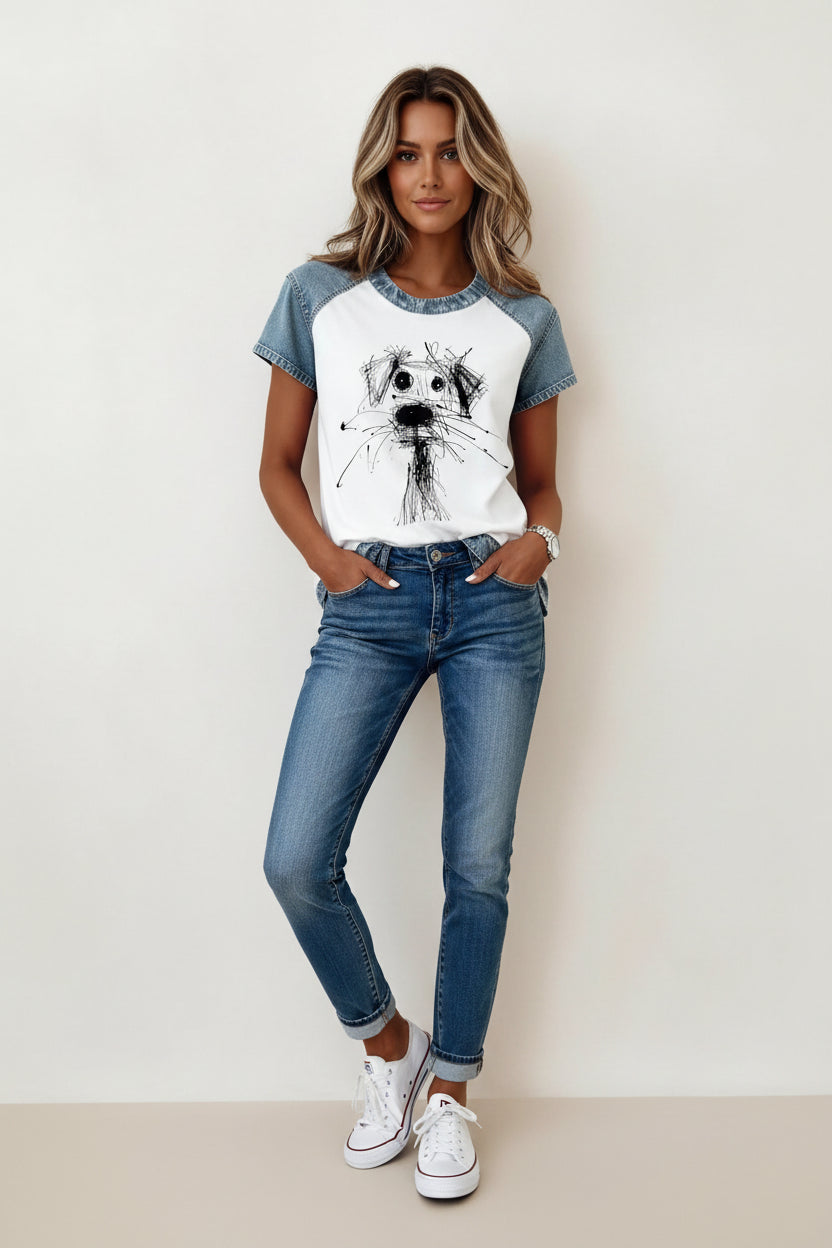 Person wearing a white t-shirt with a dog illustration and denim sleeves.