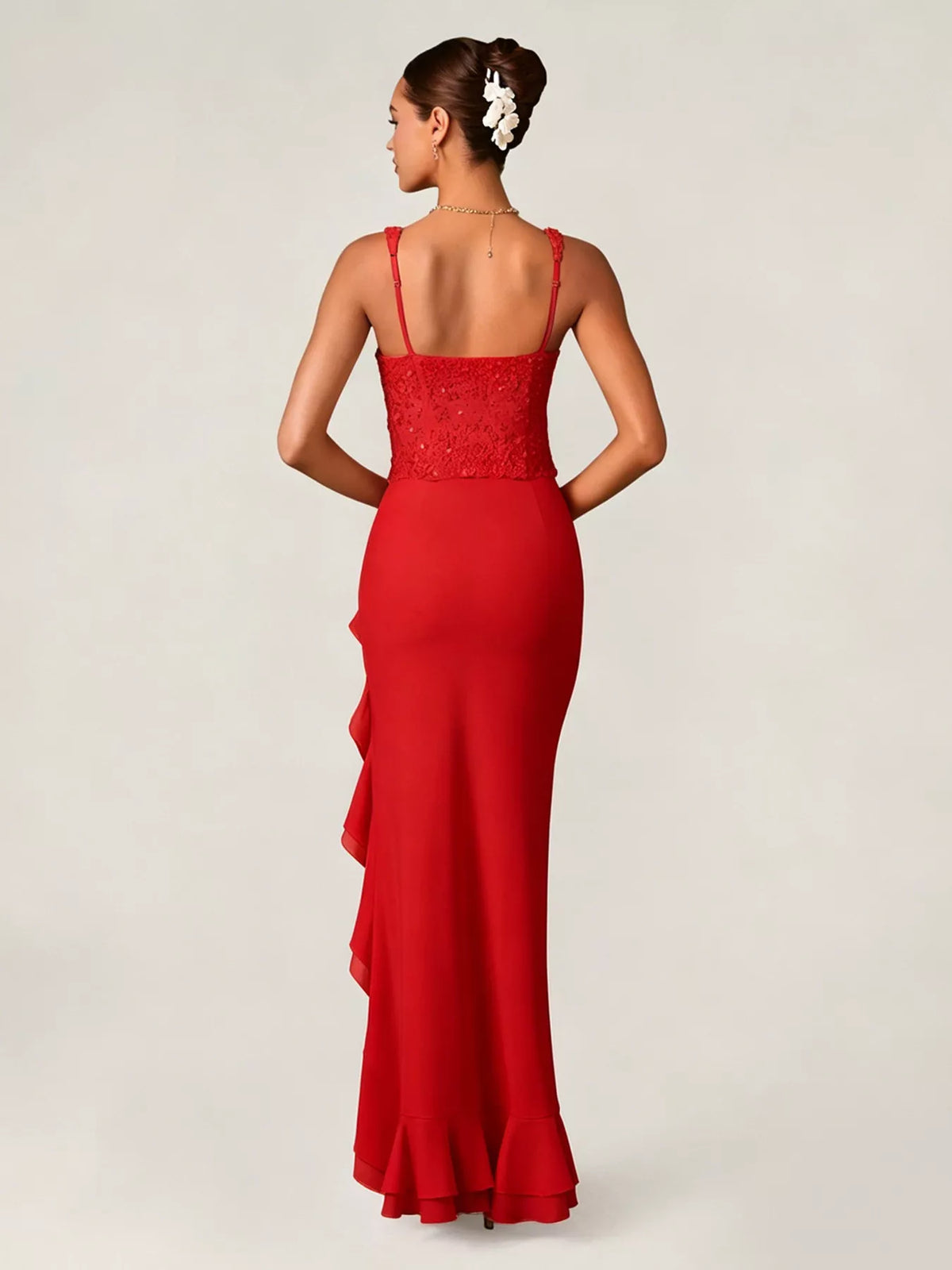 Woman wearing a red evening gown with a white background