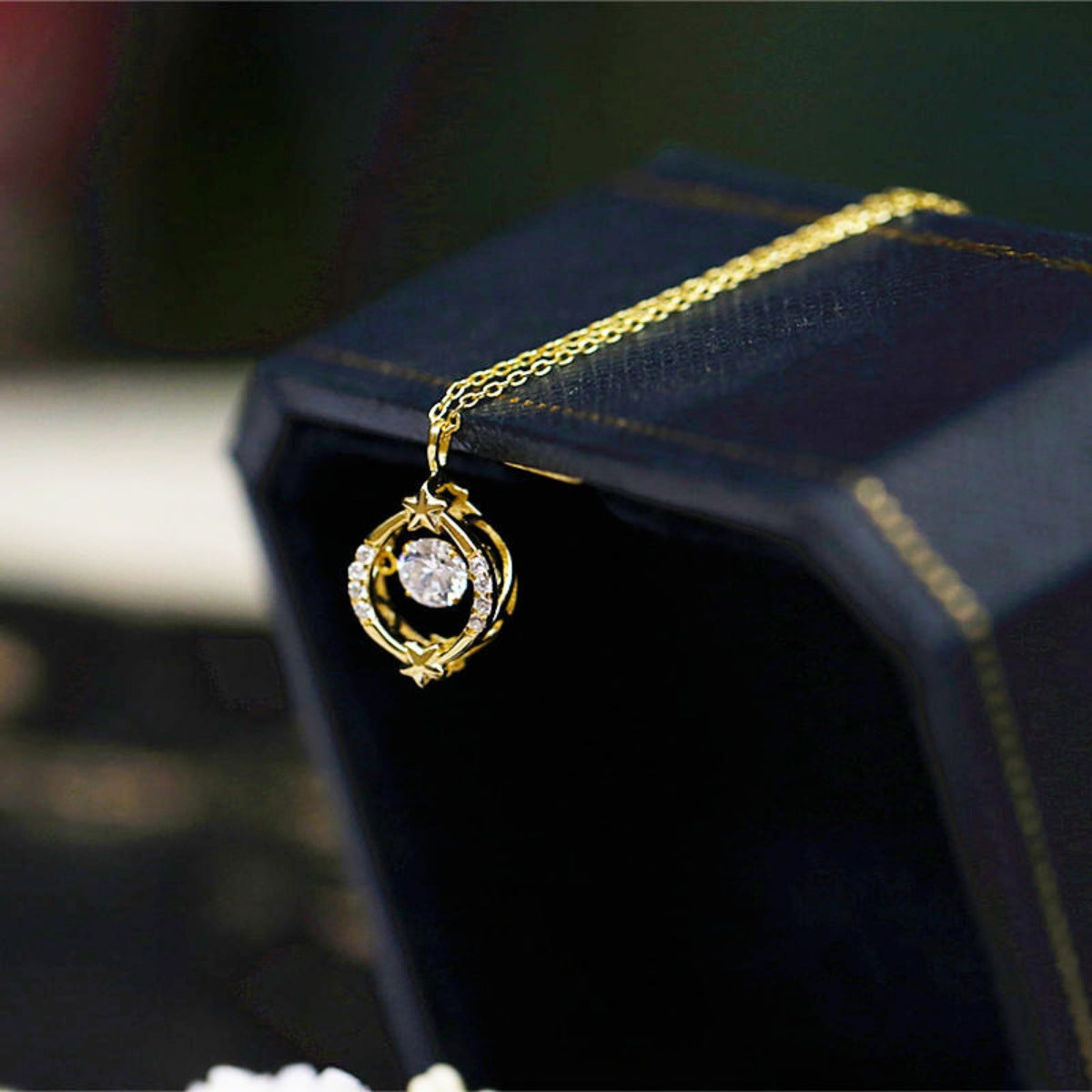 Necklace worn on model, showing delicate star circle design