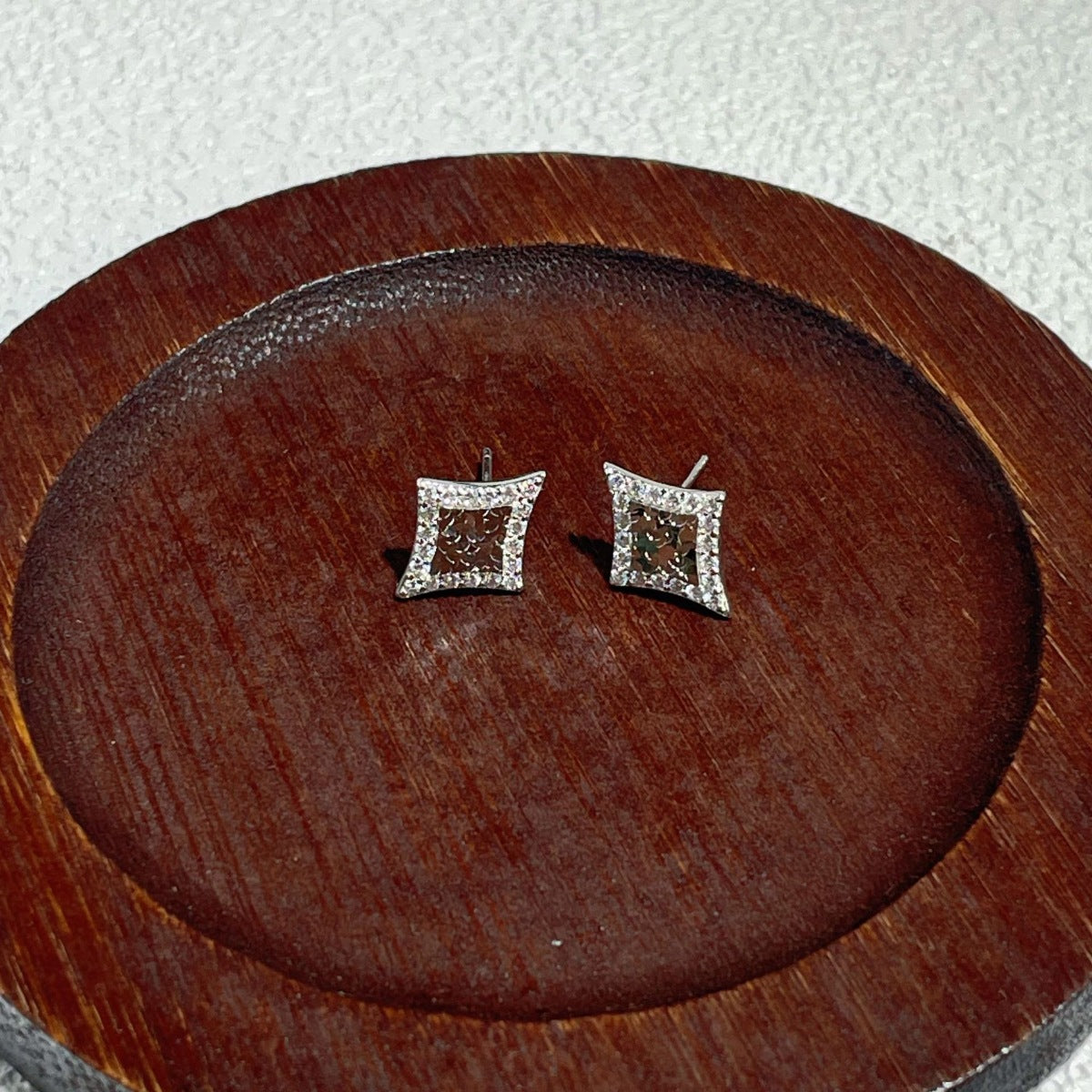 Side profile of 0.6" geometric stud earrings showing depth and design