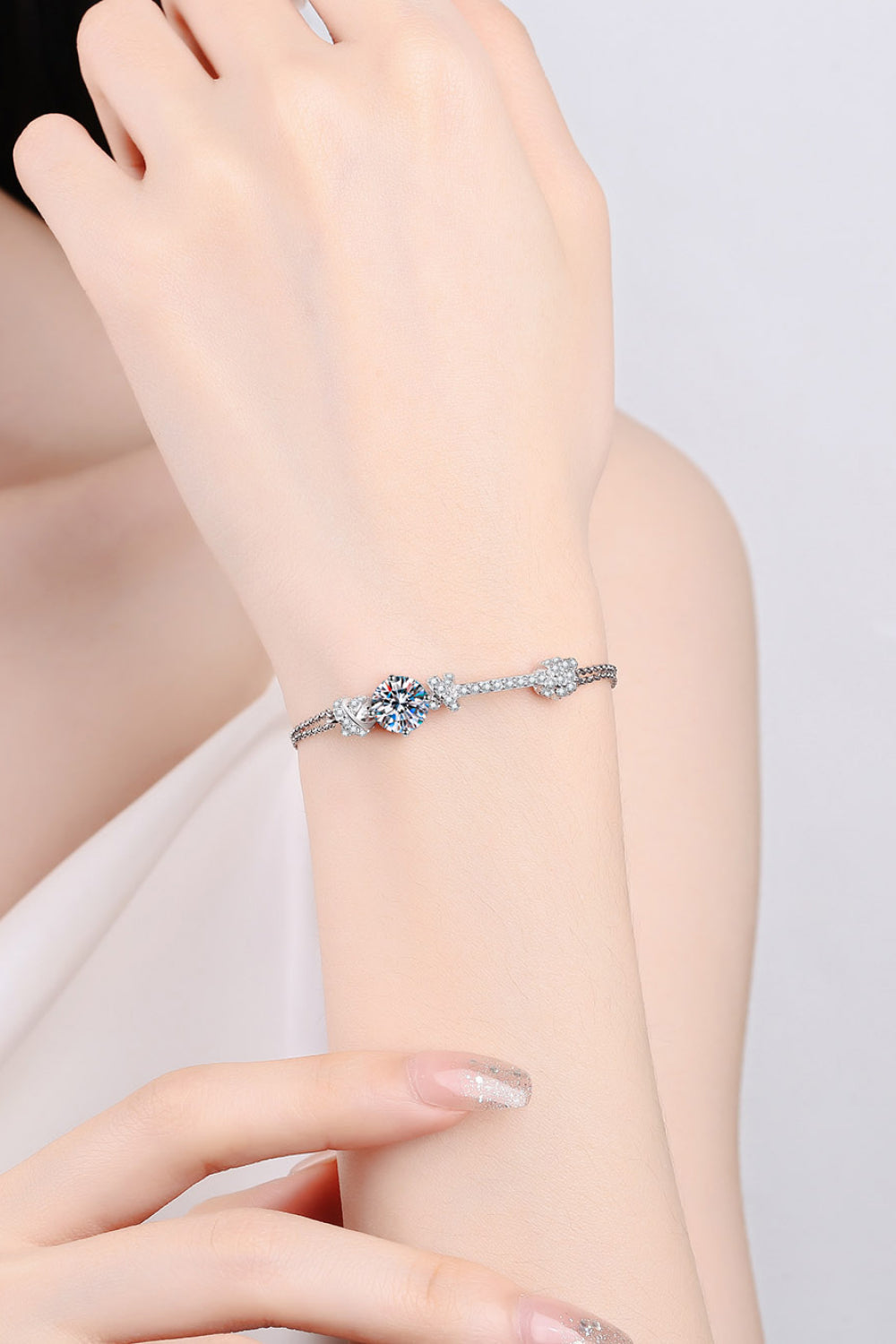 Close-up of brilliant 2 carat moissanite stones with zircon accents on rhodium-plated chain
