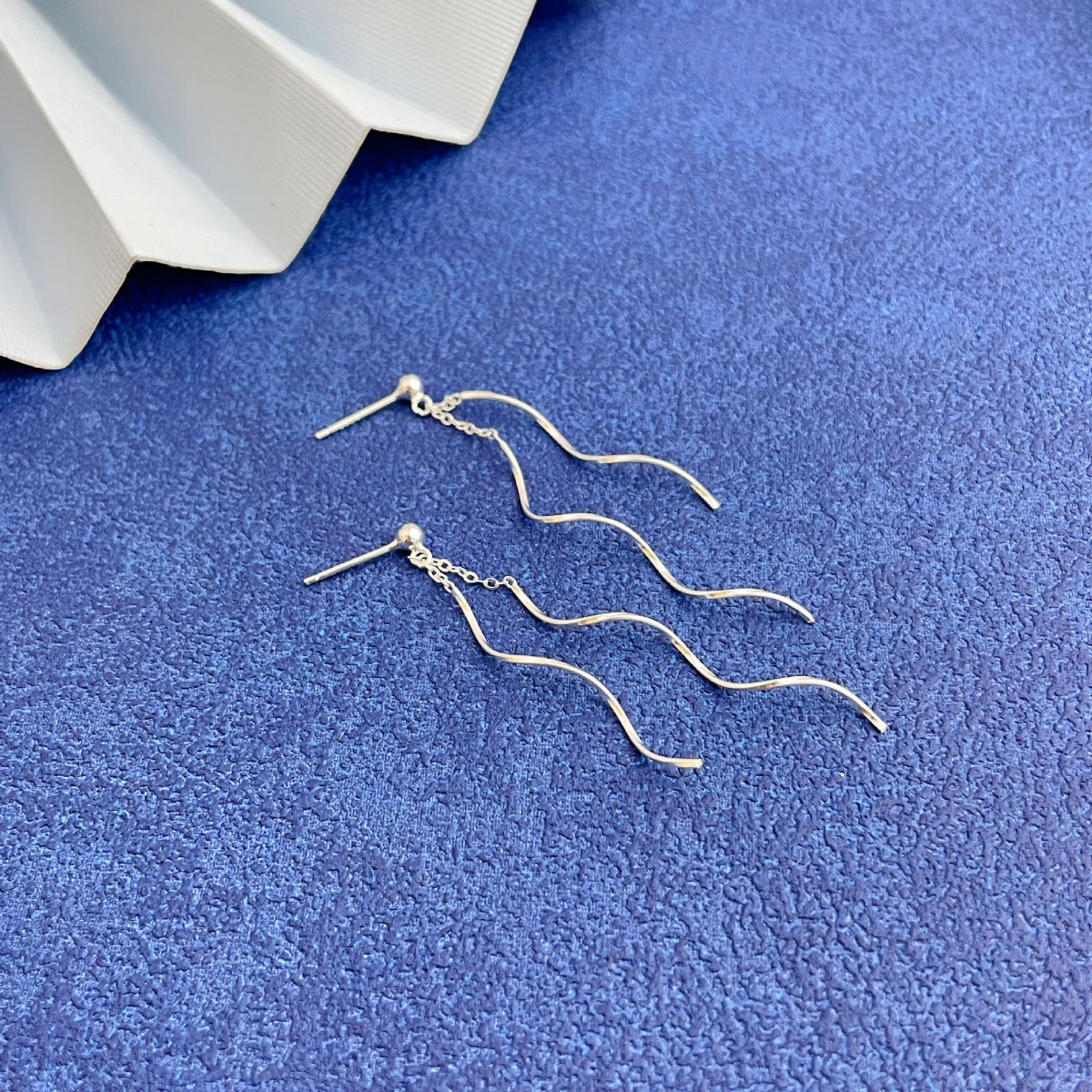 Detail shot of polished 925 sterling silver wave texture and finish