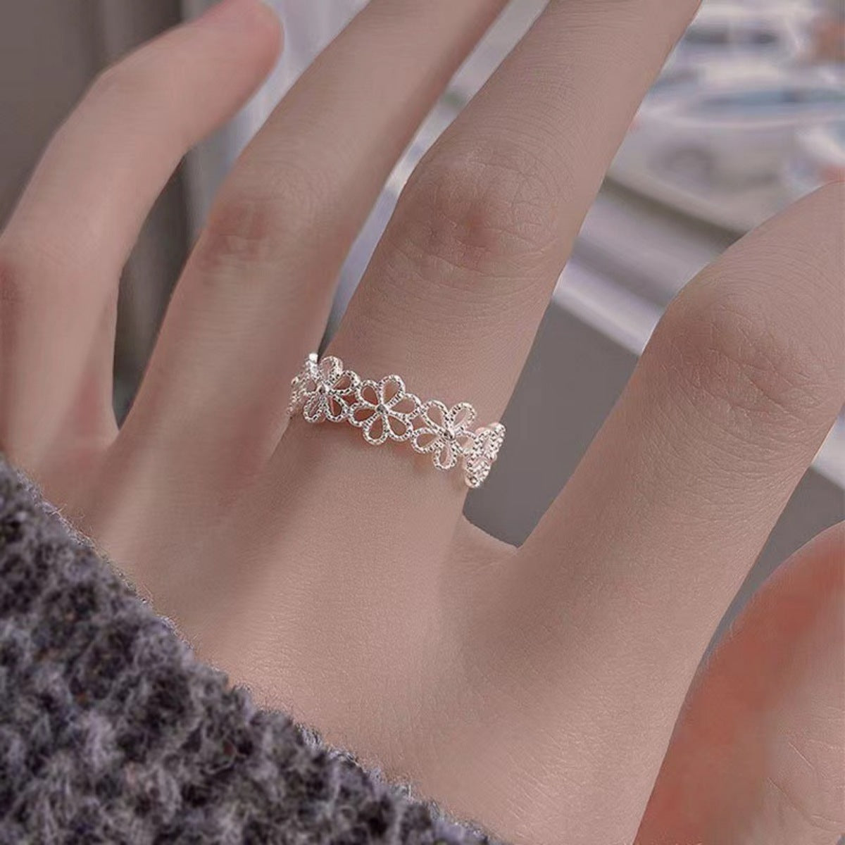 Close-up texture of etched floral details and smooth 925 sterling silver finish